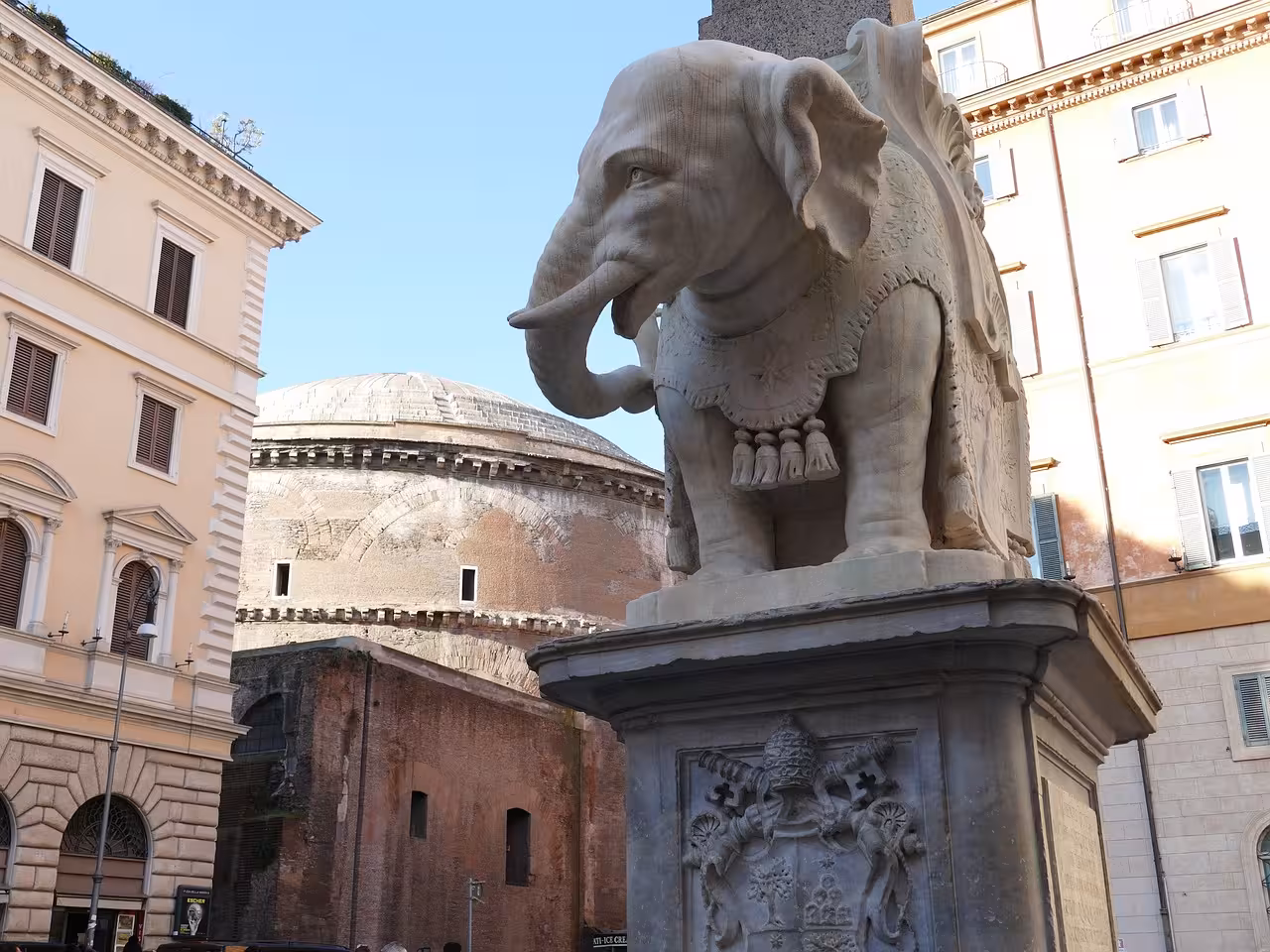 Intricately detailed elephant statue with the Pantheon in the background, highlighting Rome's artistic heritage.
