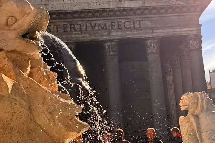 Fountain detail with Pantheon in the background, capturing the vibrant atmosphere of Rome's historic site.