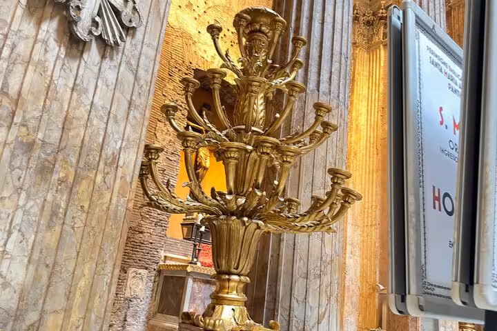 Ornate golden candelabrum inside the Pantheon, highlighting the intricate artistry and grandeur of Roman design.