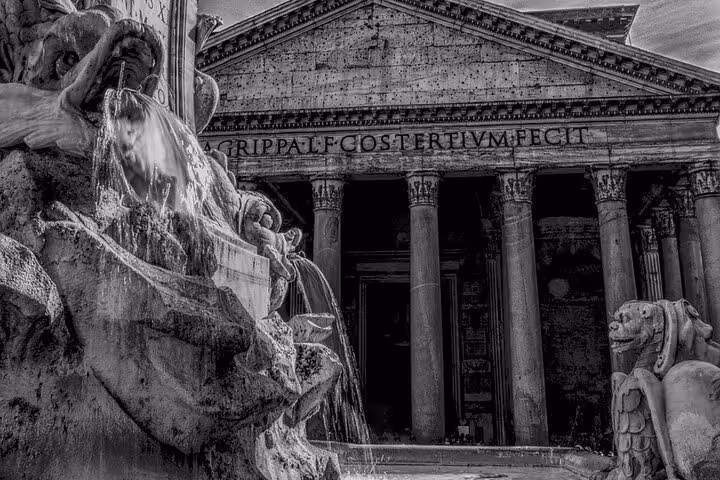 Historic Pantheon facade with fountain detail in Rome, showcasing ancient Roman architecture and design.