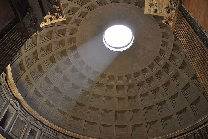 View of the Pantheon's magnificent dome with sunlight streaming through the oculus, highlighting its architectural wonder.