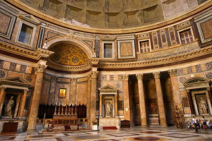 Interior view of the Pantheon in Rome showcasing its ornate ceiling and classical columns with ancient Roman design.