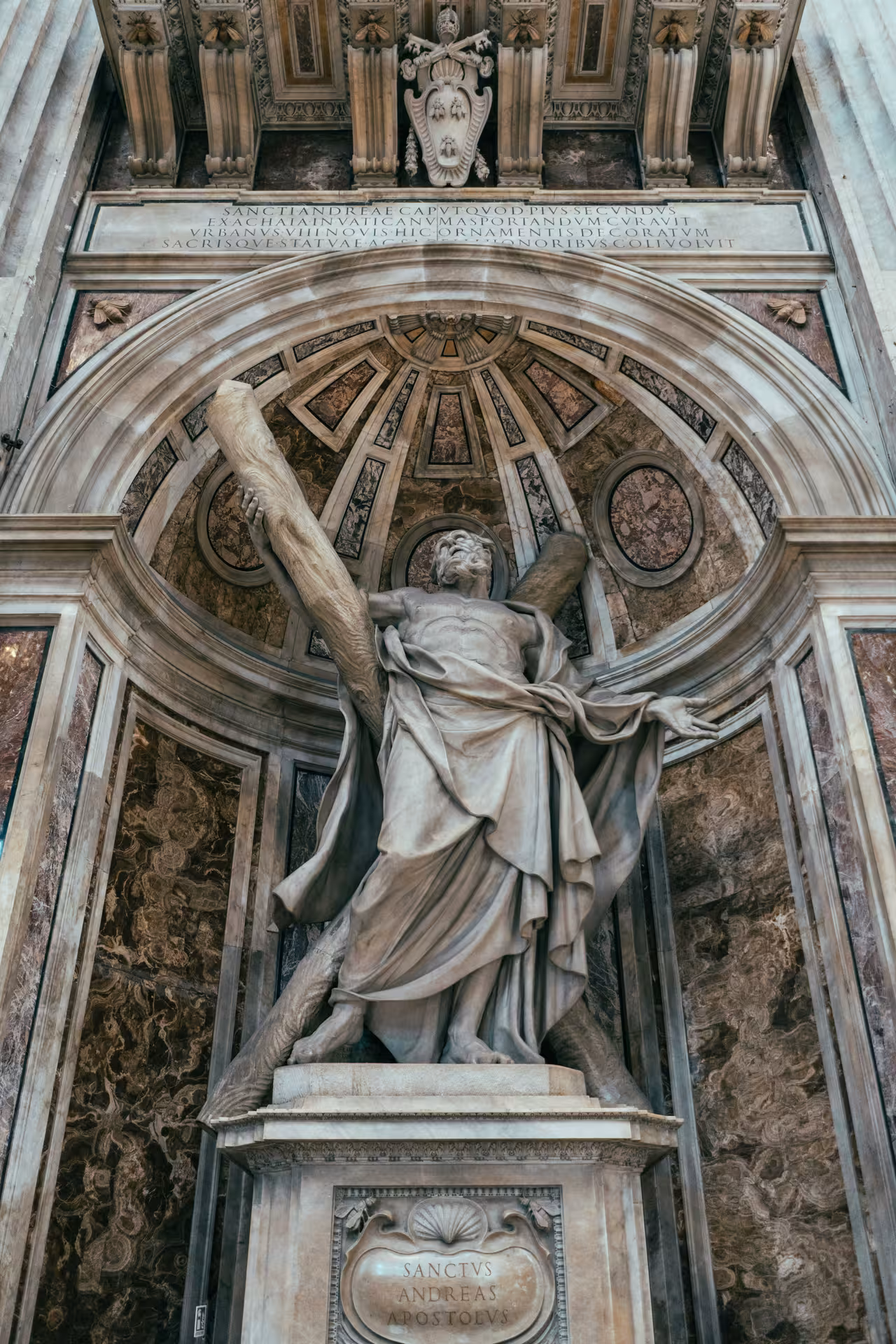 Intricate marble statue in St. Peter's Basilica, Vatican City, capturing detailed Renaissance artistry and architecture.