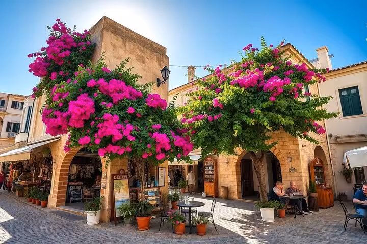 Charming Paphos old town square with bougainvillea and cafes, stop on half-day tour with hotel bus pickup