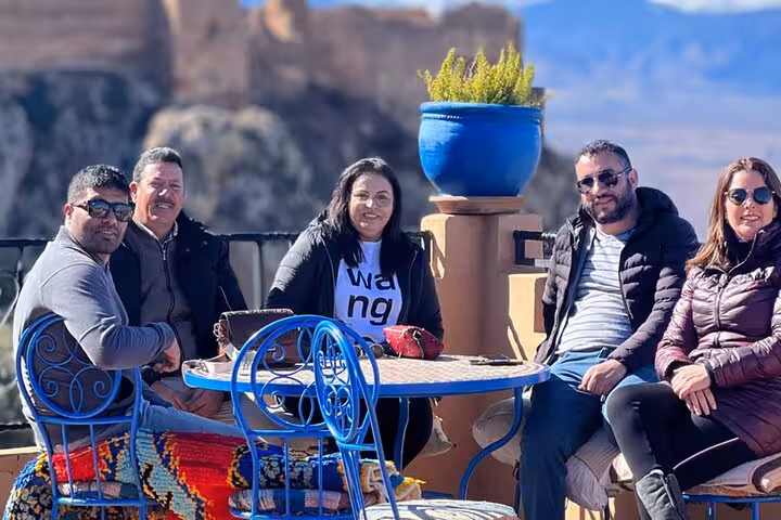 Group enjoying a scenic terrace view before paragliding in the Agafay Desert, Marrakech experience.
