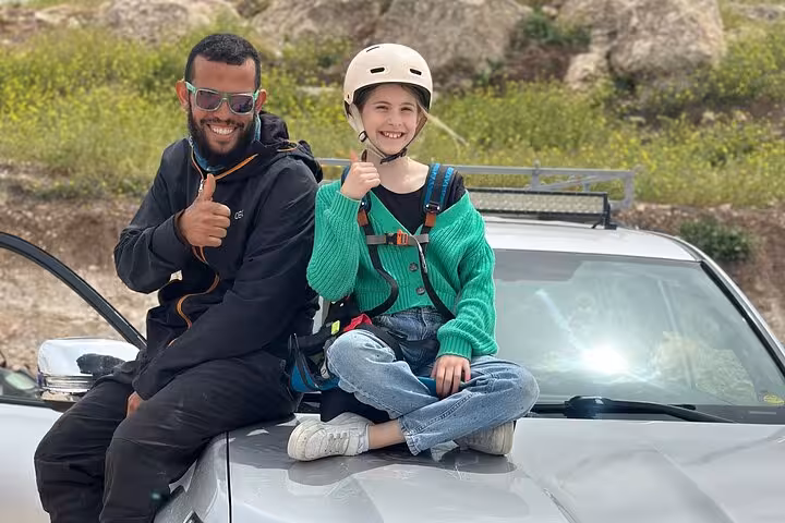 Smiling duo giving thumbs up before paragliding and quad biking adventure in Agafay Desert, Marrakech.
