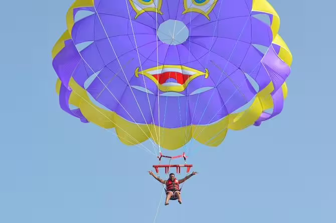 Single parasailer under purple canopy soaring high in Hurghada, Red Sea parasailing adventure with panoramic views