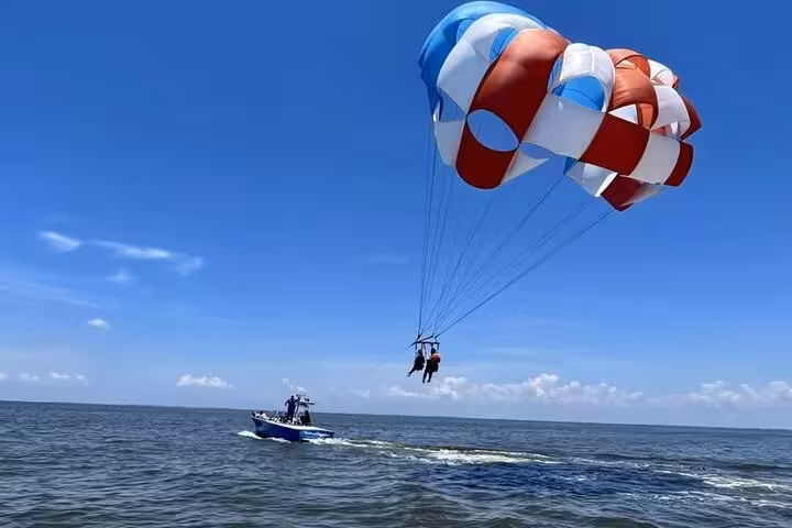 Parasailing ride behind speedboat on the Red Sea from Sharm El Sheikh, with private hotel transfers