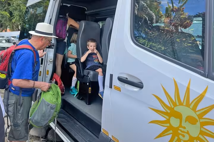 Passengers boarding a comfortable van for a shared transfer from Paraty to Angra Dos Reis, ideal for family travel.