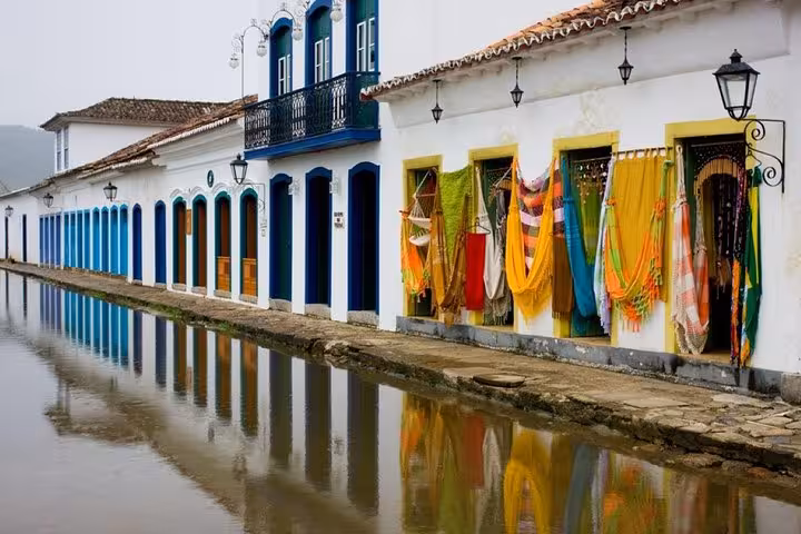 Colorful colonial buildings reflected in water in Paraty's historic center on a private walking tour by Paraty Tours.