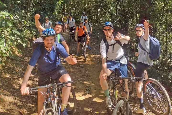 Group of cyclists enjoying a two-hour guided bike tour through lush trails in Paraty's scenic landscape.