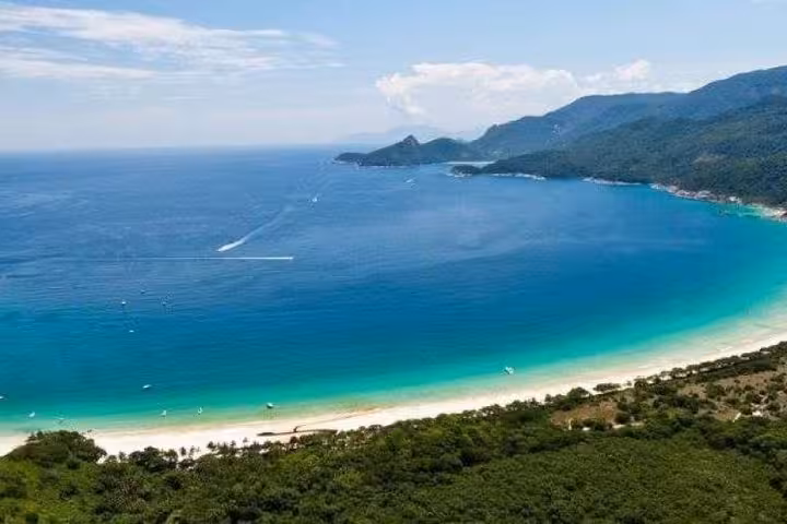 Stunning aerial of Ilha Grande's turquoise waters and lush coastline, highlighting its natural beauty and travel appeal.