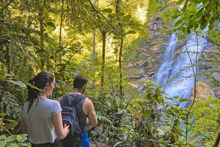 Hikers explore lush trails leading to the scenic Melancia Waterfall in Paraty, ideal for trekking and hiking enthusiasts.