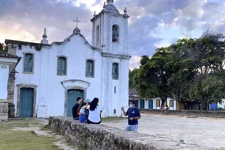 Visitors enjoying a private walk tour at a historic church in Paraty's charming historical center.