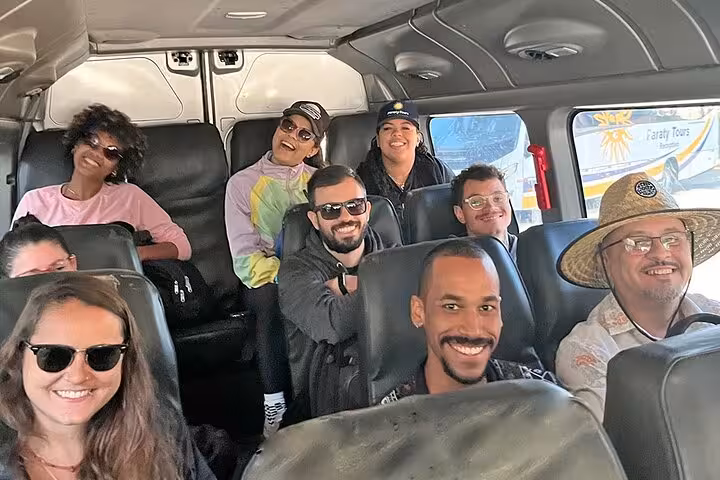 Happy travelers inside Paraty Tours van enjoying shared transfer service from Paraty to Rio de Janeiro.