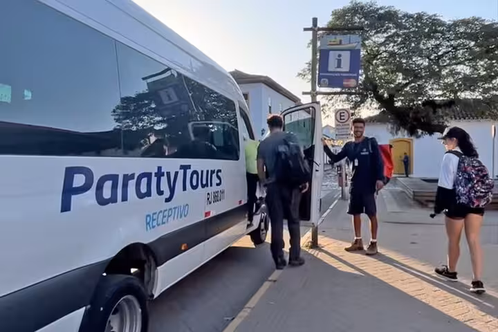 Travelers boarding a Paraty Tours van for a convenient shared transfer to Angra Dos Reis, highlighting seamless service.