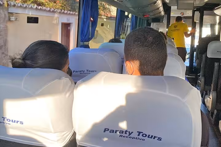 Passengers seated inside a Paraty Tours van, enjoying a relaxed shared transfer to Rio de Janeiro hotels.