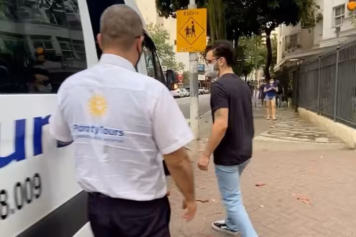 Travelers boarding a shared transfer van in Paraty for a scenic journey to Angra Dos Reis.