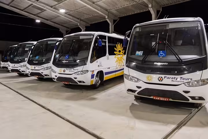 Row of Paraty Tours shuttle buses at Rio de Janeiro airport, ready for comfortable transfers to Paraty.