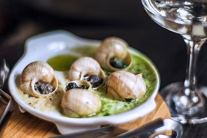 Classic escargot dish in garlic butter sauce, a must-try on the Paris food tour in Le Marais.