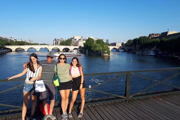 Family enjoying a sunny day on a Parisian bridge over the Seine River, perfect for a private family tour and kids' museum visit.