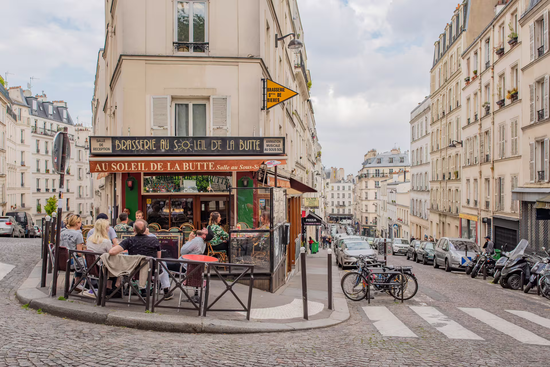 Paris brasserie terrace on a Montmartre street, scene from 1-day Paris foodie walking tour with audioguide