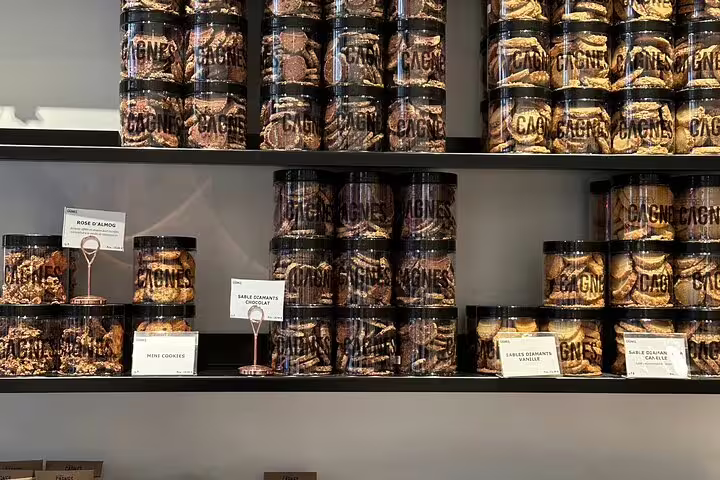 Shelves filled with a variety of gourmet cookies in jars, featured in the Paris Gourmet Tour experience.