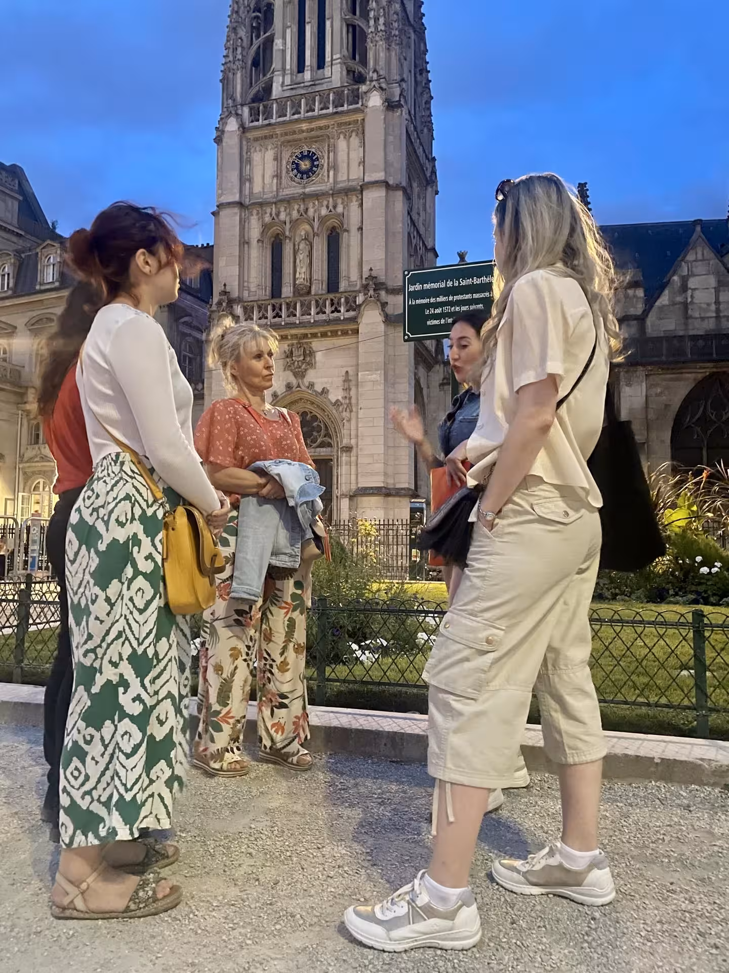 Tour guide explaining history to a group outside the Saint-Jacques Tower during the Paris Justice and Crime Tour.