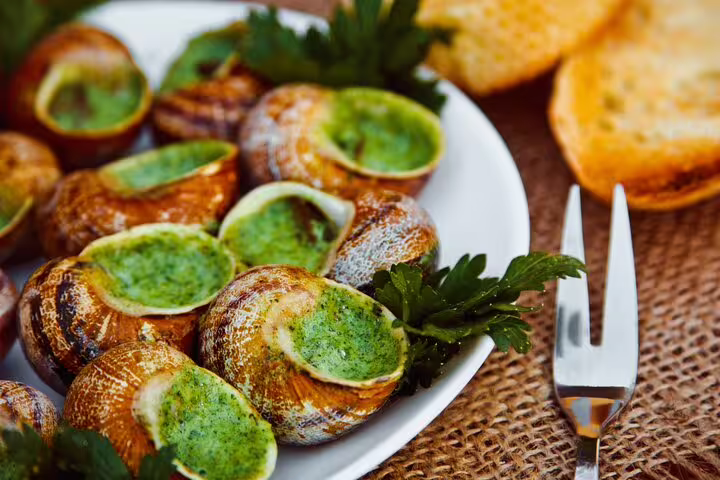 Delight in authentic French escargot with garlic butter on the Paris Le Marais Flavors of France private walking food tour.