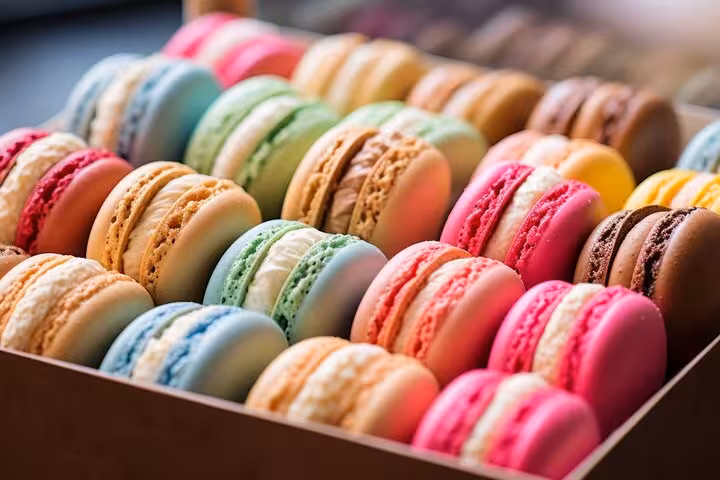 Colorful French macarons in a Paris pâtisserie box, sweet tasting stop on Arc de Triomphe private tour