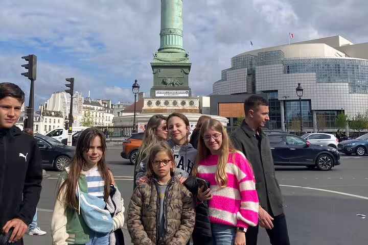 Group at Place de la Bastille beside the July Column during a Paris Marais scavenger hunt walking tour