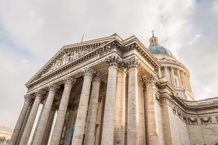 Majestic view of the Pantheon in Paris, highlighting its grand columns and dome, featured in our Louvre and Sainte Chapelle tour.