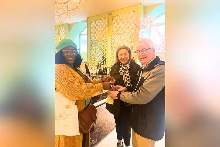 Guests enjoy macaron tasting on a private Paris tour, stopping at a chic shop near Champs-Élysées