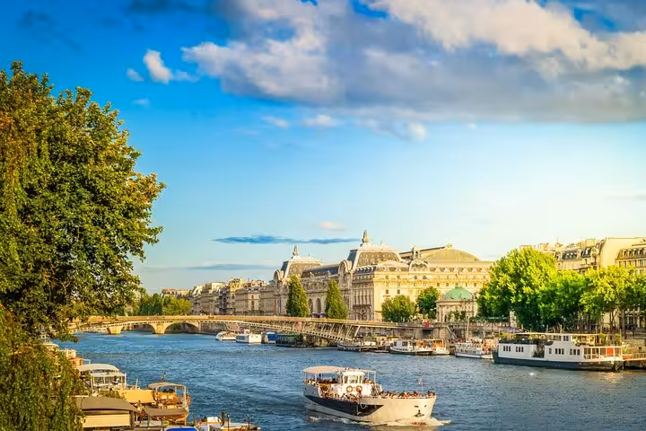Seine River view in Paris with boats and riverside landmarks on a private Seine walk near Love Locks Bridge