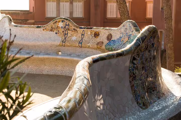 Close-up of Park Güell's colorful mosaic bench, showcasing Gaudí's artistic flair and unique design.