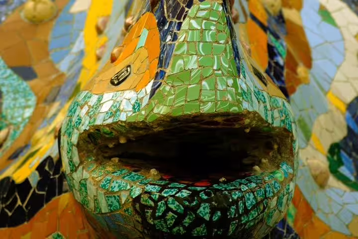 Close-up of colorful mosaic lizard sculpture at Park Güell, Barcelona, featured in a private tour with Sagrada Familia and tapas.