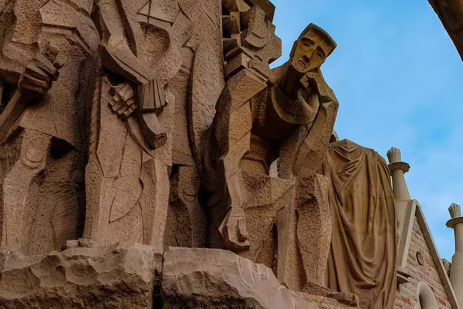 Intricate stone sculptures on the facade of Park Guell, showcasing Gaudí's unique artistic style.