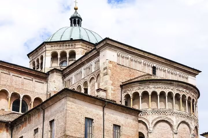 Romanesque Parma Cathedral exterior with ornate arches and dome visited on a guided private walking tour of Parma