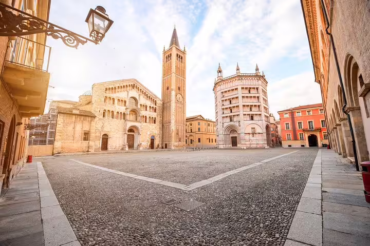 Quiet morning view of Parma’s Piazza Duomo with the Romanesque cathedral, bell tower and baptistery on a private walking tour
