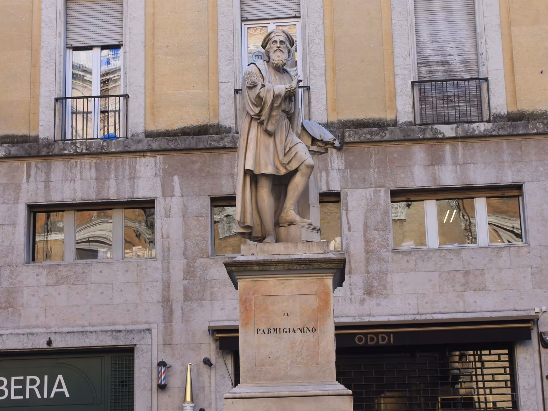 Historic statue in Parma city center, showcasing Renaissance art and cultural landmarks on a sightseeing tour.