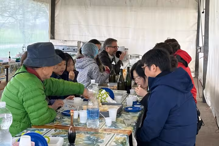 Guests enjoy gourmet tasting of Parmesan cheese and balsamic vinegar during immersive Italian culinary tour.