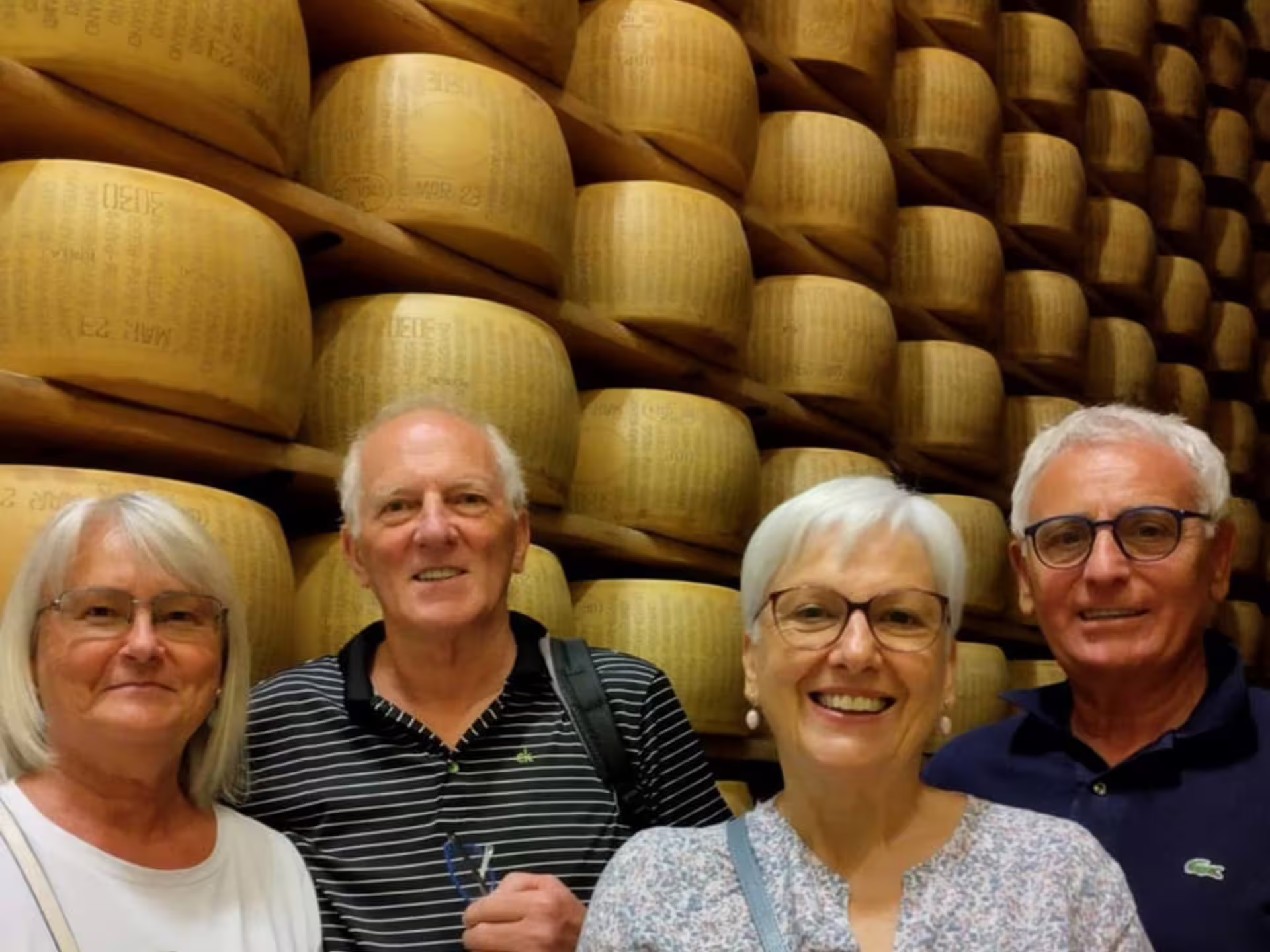 Artisan cheesemakers craft Parmesan wheels in copper vats during an interactive factory tour near Parma.