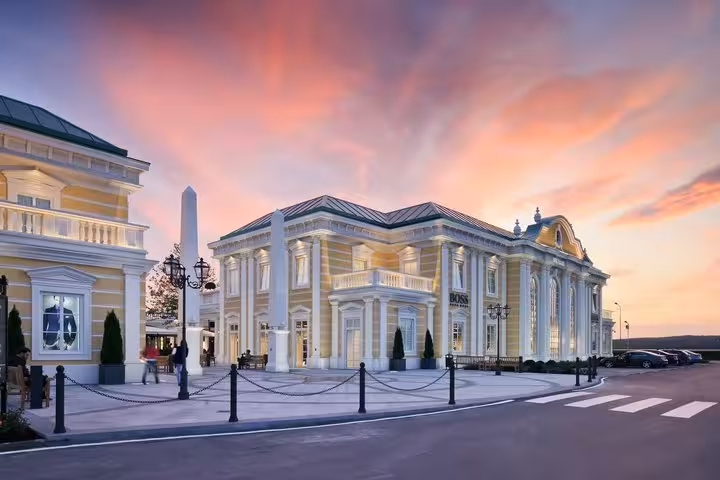 Parndorf Designer Outlet near Vienna at sunset, stop on Budapest to Vienna private transfer for shopping