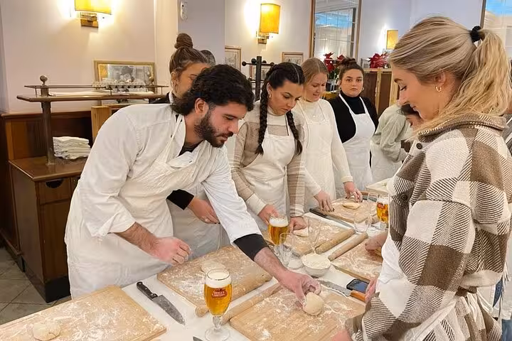 Participants learn pasta making at a Rome cooking class with hands-on guidance from an expert chef.