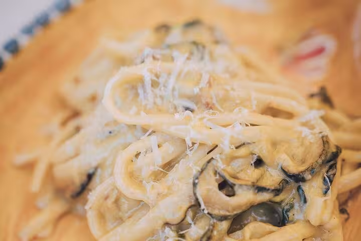 Creamy pasta with zucchini and Parmesan, a delightful dish for a wine pairing lunch under Sorrento lemon trees.