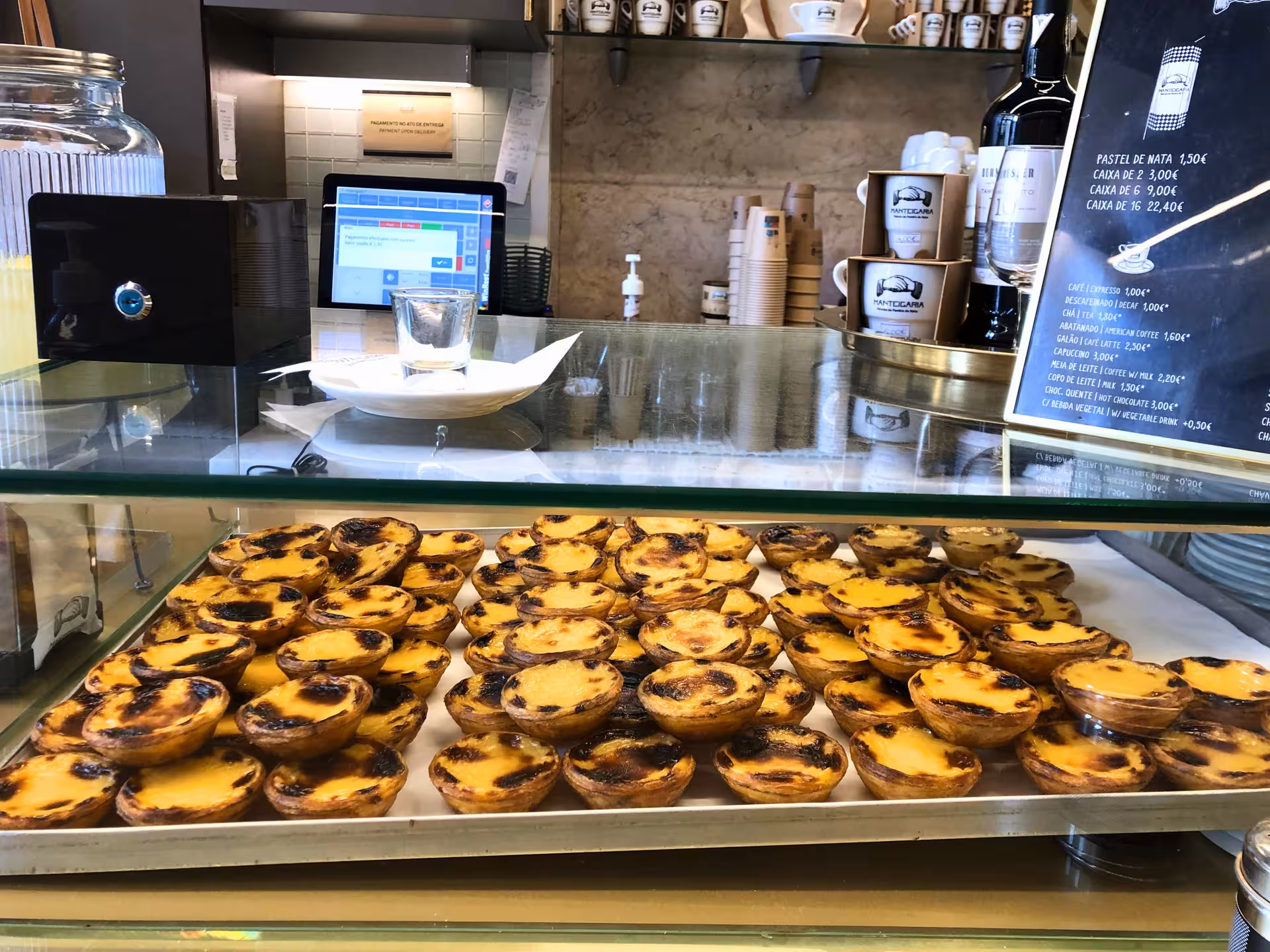 Pastéis de nata in a traditional Lisbon bakery counter, a sweet stop on the Old Shops & Stories tour