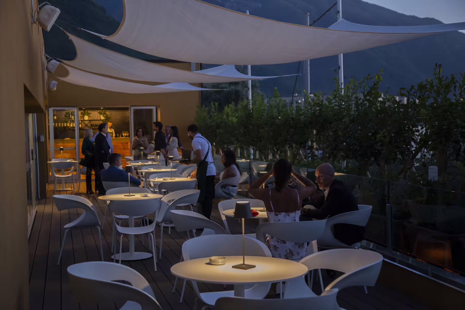 Guests enjoy an evening aperitivo on a panoramic terrace during the Visita al pastificio food and wine experience