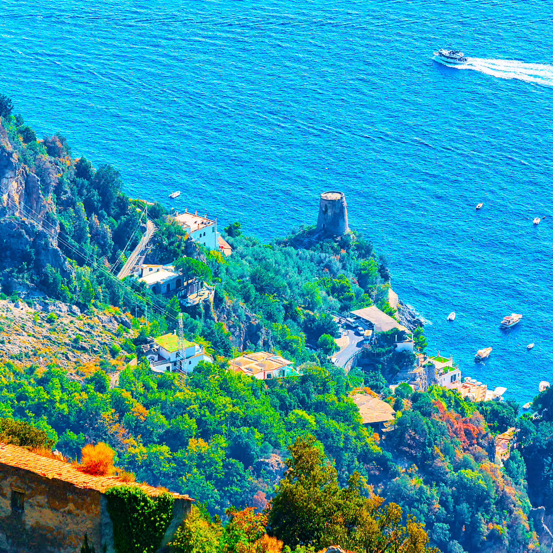 Clifftop Path of the Gods view over turquoise Amalfi Coast waters, watchtower ruins and lush terraced hills