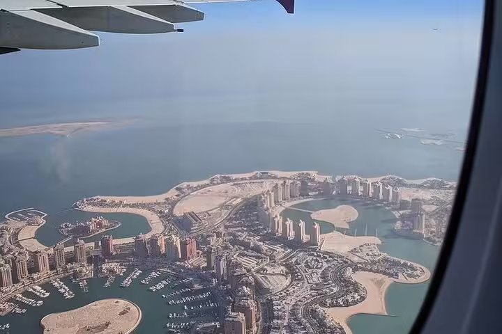 Aerial view of The Pearl-Qatar's iconic architecture, captured from an airplane on the Doha Transit City Tour.