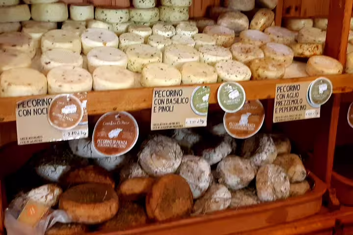 Display of assorted pecorino cheeses in a Tuscan shop, sampled on the Chianti and San Gimignano wine tour with lunch